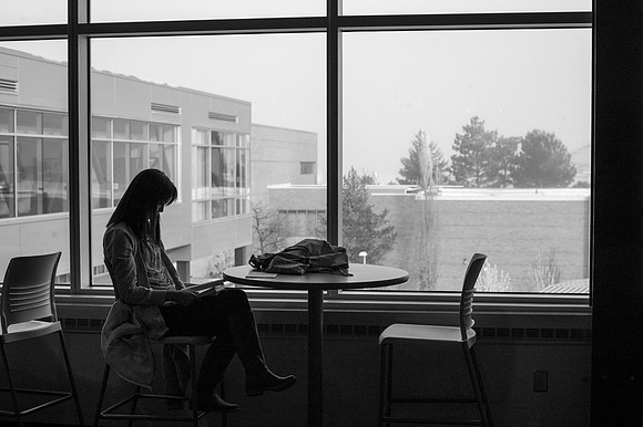 A student looks over her textbook in the Crossroads.