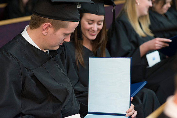 Students of the College of Human Development receive their diploma cover.