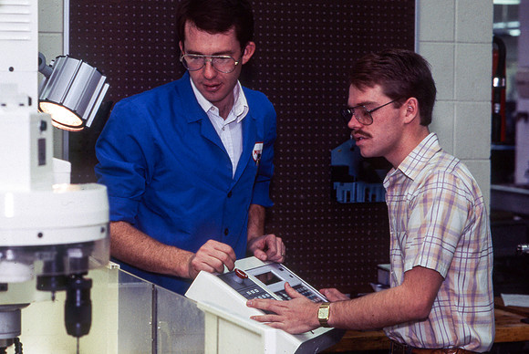 Teacher and Student work alonside one another with Manufacturing Technology. December 1990.