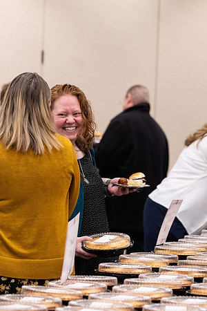 Employees gather for the annual Christmas gathering with President and Sister Meredith.