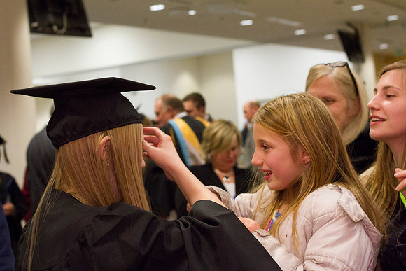 A family helps a graduate fix her cap in the Taylor Chapel after Convocation.