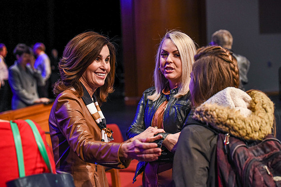 Sister Lisa L. Harkness, first Counselor in the Primary General Presidency, meets devotional participants in the BYU-Idaho Center.