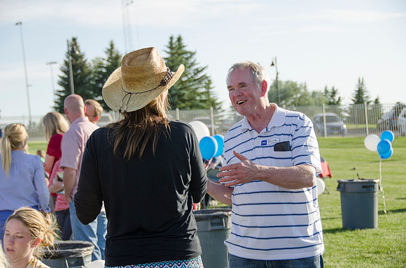 Online instructors gather with their families for an eveing of BBQ and games.