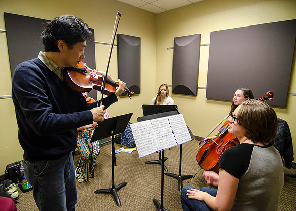 A member of the Shanghai String Quartet working with student ensembles.
