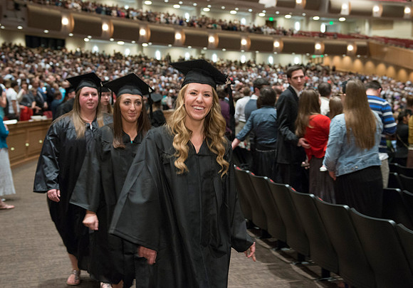 Graduates gather and march in during the processional for April 2014 Graduation ceremonies in the BYU-Idaho Center.