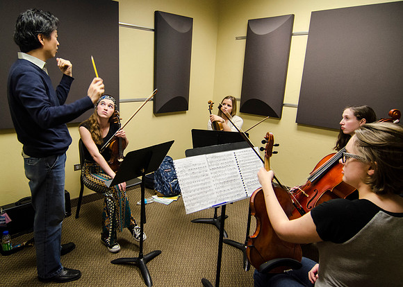 A member of the Shanghai String Quartet working with student ensembles.