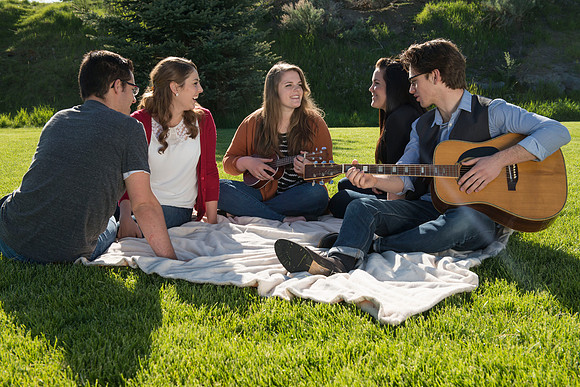 Student models interact and smile for marketing purposes that will be used for the new Campus Housing next to The Ivy.
