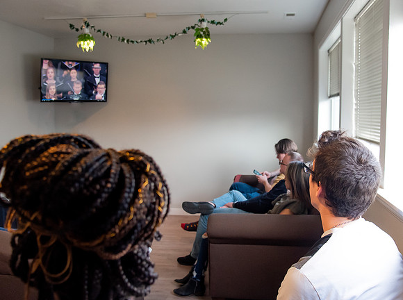 BYUI graduate Renata Flores watches Winter 2021 Commencement in her home with friends.