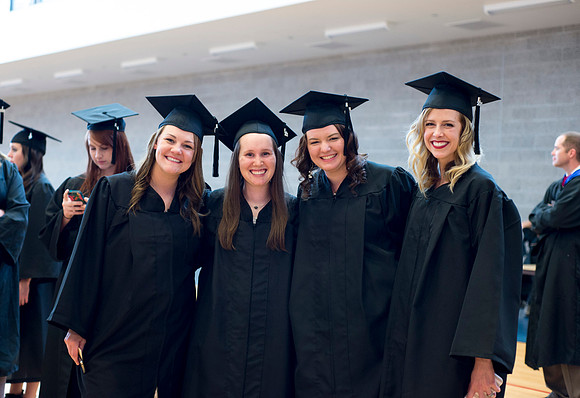 Graduates wait inside the gym area preparing to enter Commencement ceremony.