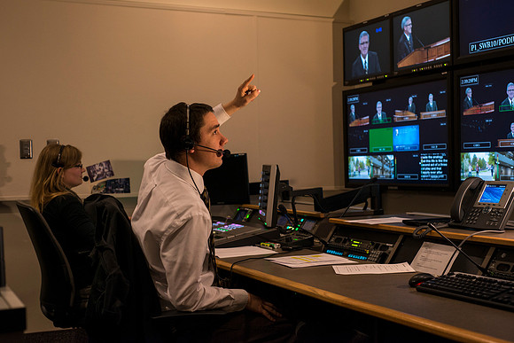 Behind the scenes of devotional in the AV_Control Room. Mike Jeffs directs the camera's during devotional.