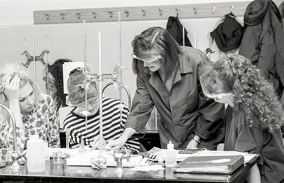 Chemistry teacher, Susan Ward, works with students during their Chemistry lab. December 1995.