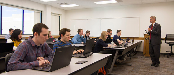 Students listen and take notes as Brother Kevin Packard teaches Intermediate Financial Accouting in the Smith Building.