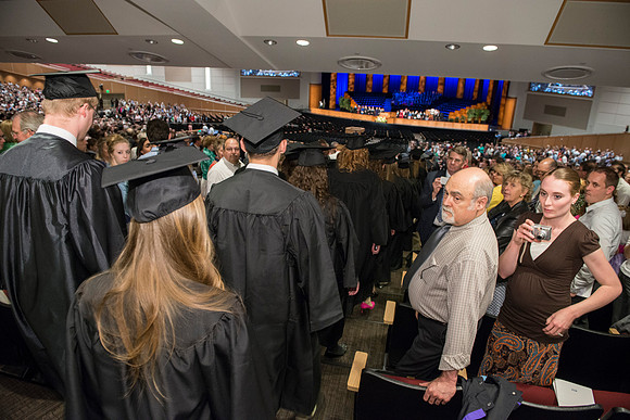 Graduates gather and march in during the processional for April 2014 Graduation ceremonies in the BYU-Idaho Center.