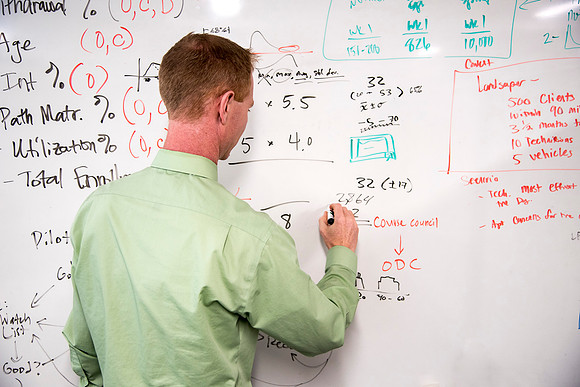 Employees work on developing a better curriculum for online students.