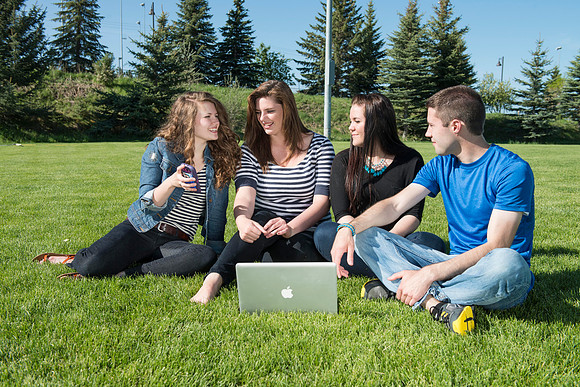 Student models interact and smile for marketing purposes that will be used for the new Campus Housing next to The Ivy.