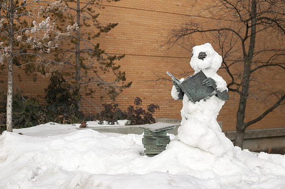 The Bookworm, statue outside of the David O. McKay library, stands covered in snow.
