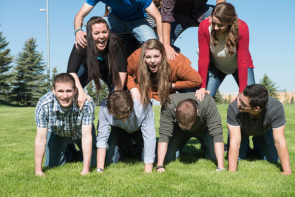 Student models interact and smile for marketing purposes that will be used for the new Campus Housing next to The Ivy.