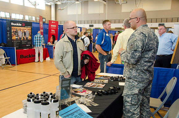 BYU-Idaho students speak to representatives from colleges or companies from their field of study at a career fair held in the I-Center gym