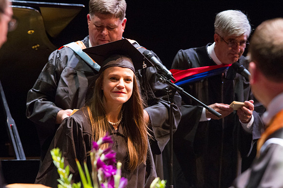 Dean's of the College of Performing and Visual Arts award diplomas to graduates during convocation held in the Snow Building. Photo by Tyler Rickenbach