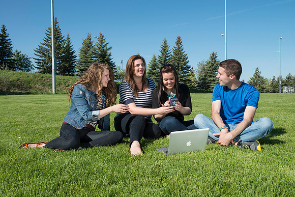 Student models interact and smile for marketing purposes that will be used for the new Campus Housing next to The Ivy.