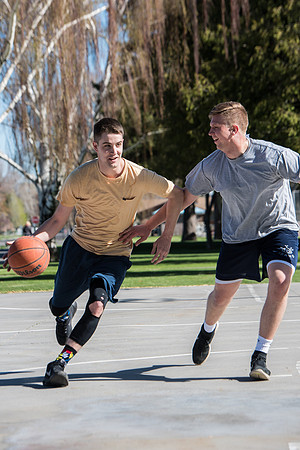 Jacob and Jacob, two BYU-Idaho students, play one on one basketball at the Smith Park court.
