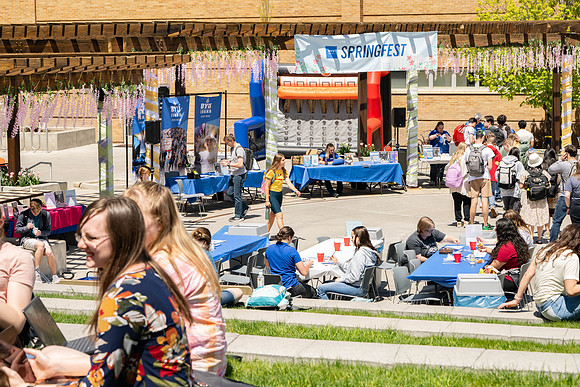 Spirit Fest Booths on campus, students talking and having fun together.