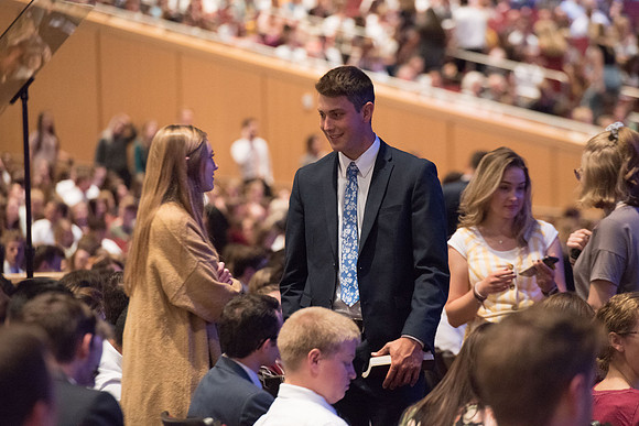 BYU-Idaho Devotional. Guest speaker Elder David A. Bednar and his wife. Students getting ready to listen. Fall Semester