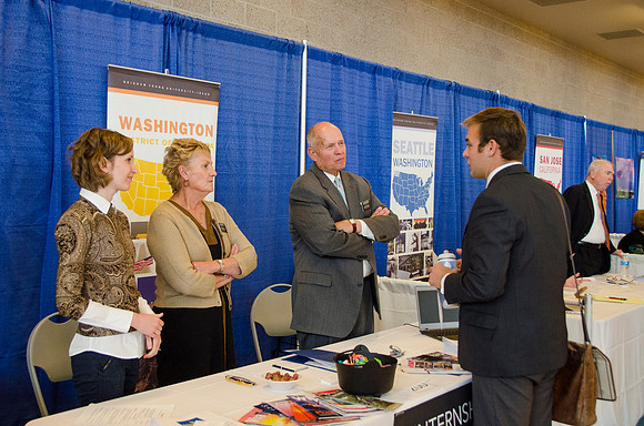 BYU-Idaho students speak to representatives from colleges or companies from their field of study at a career fair held in the I-Center gym