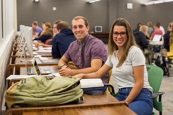 Students prepare for their classes, in the McKay Library.
