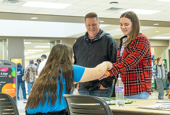 Student with her father getting a wristband.