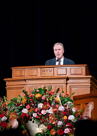 Elder and Sister Boom speak at devotional in the BYUI Center.