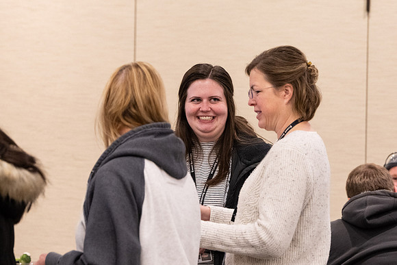 Employees gather for the annual Christmas gathering with President and Sister Meredith.