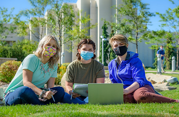 Student volunteers show the way to stay safe during this COVID 19 pandemic by social distancing, following pathway arrows and proper wearing of masks .