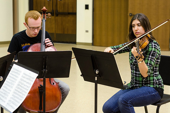 A member of the Shanghai String Quartet working with student ensembles.