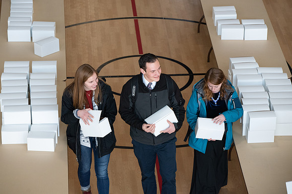 Students pick up their $2 box lunch after devotional for the first time.