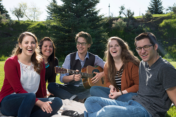 Student models interact and smile for marketing purposes that will be used for the new Campus Housing next to The Ivy.
