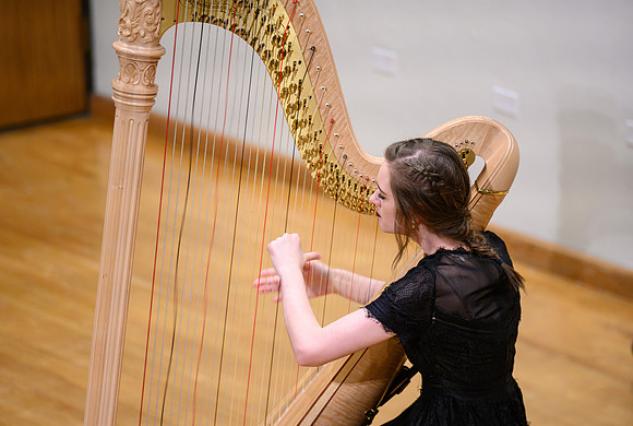 The harp ensemble performs in the recital hall in the Snow building.