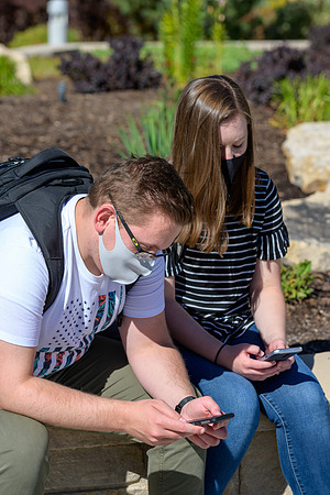 Student volunteers show the way to stay safe during this COVID 19 pandemic by social distancing, following pathway arrows and proper wearing of masks .