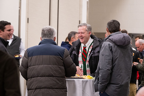 Employees gather for the annual Christmas gathering with President and Sister Meredith.