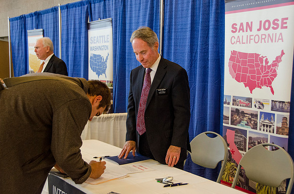 BYU-Idaho students speak to representatives from colleges or companies from their field of study at a career fair held in the I-Center gym