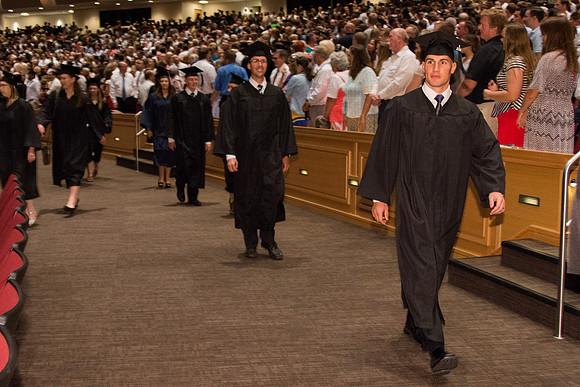 BYU-Idaho graduates walk in to the commencement ceremony, held in the BYU-Idaho Center.