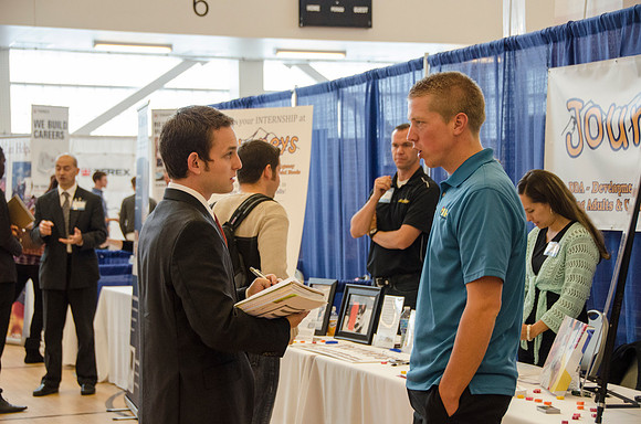 BYU-Idaho students speak to representatives from colleges or companies from their field of study at a career fair held in the I-Center gym