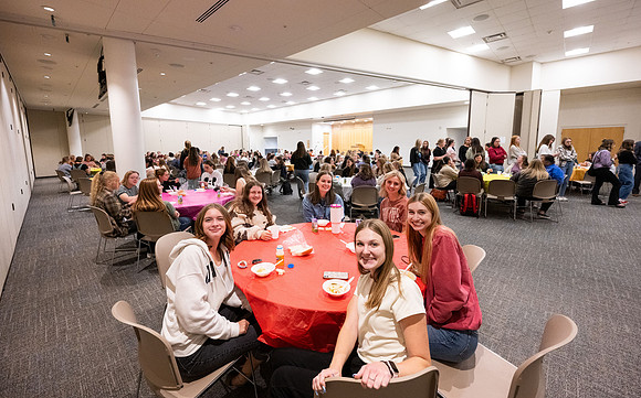 Taylor building room 160 and 170 set up with round tables for a Stake Relief Society Social.
