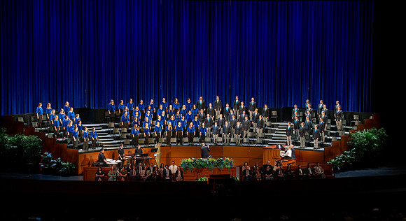 Women and men choir performing during devotional.