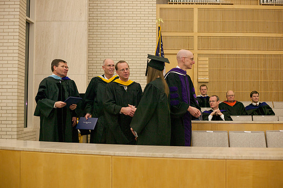 Advancement Vice President Henry J. Eyring congratulates students in the Taylor Chapel.