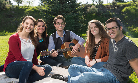 Student models interact and smile for marketing purposes that will be used for the new Campus Housing next to The Ivy.