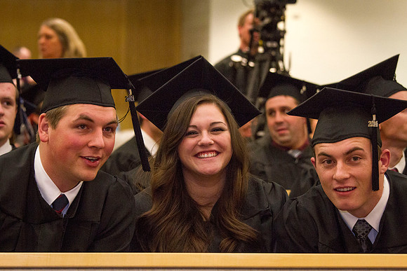 Students smile after receiving their diplomas in the Taylor Chapel.