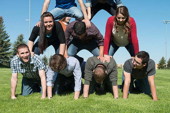 Student models interact and smile for marketing purposes that will be used for the new Campus Housing next to The Ivy.