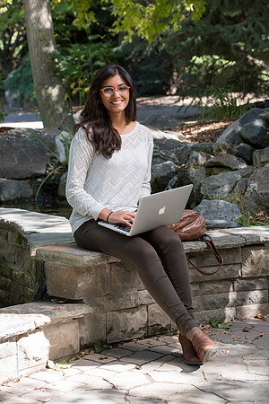 Student Noor Sofi poses in the Gardens for online learning.