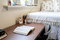 Scriptures on a desk in a clean student bedroom